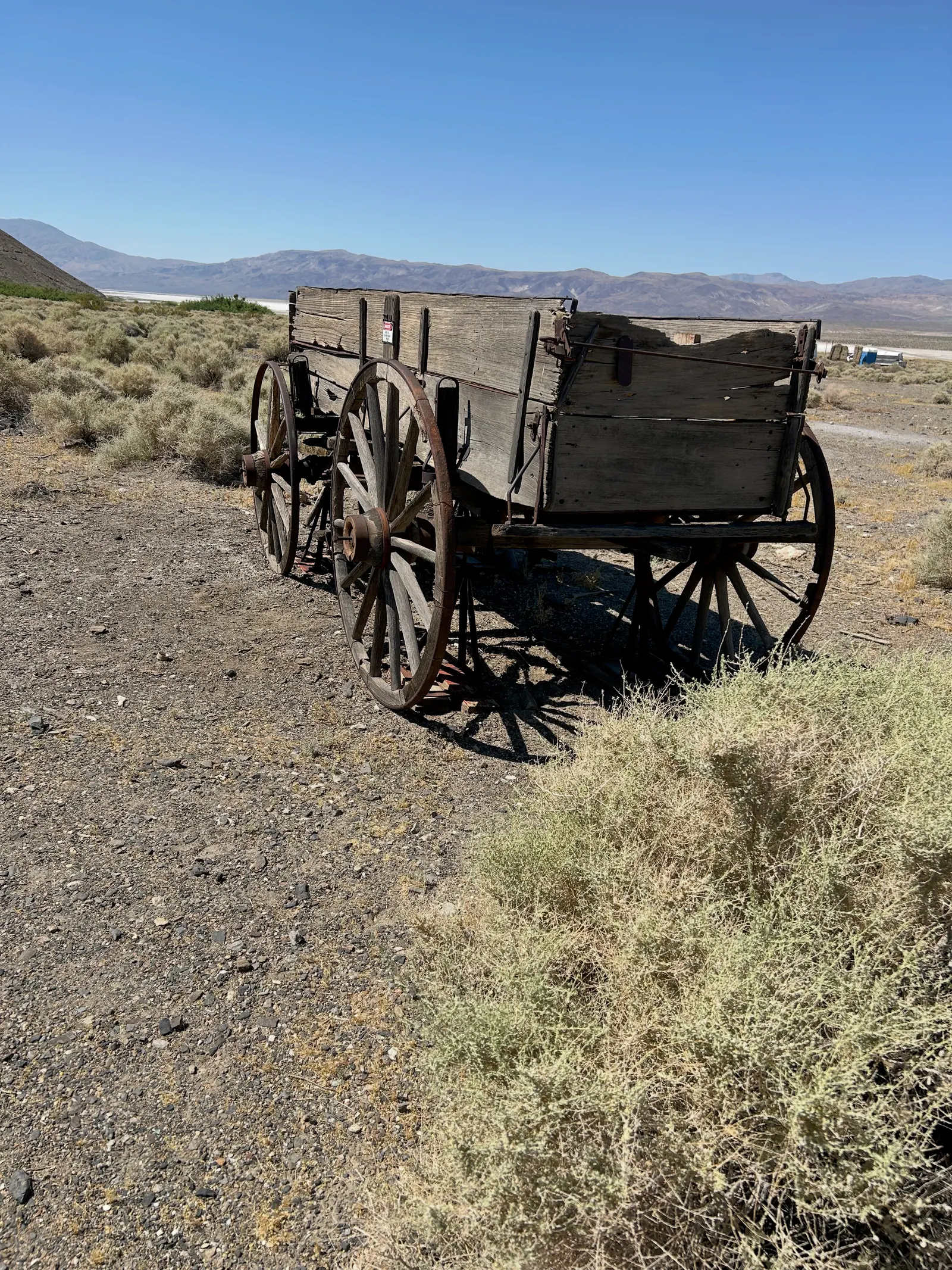 A weathered wooden wagon stands in the open Ballarat desert